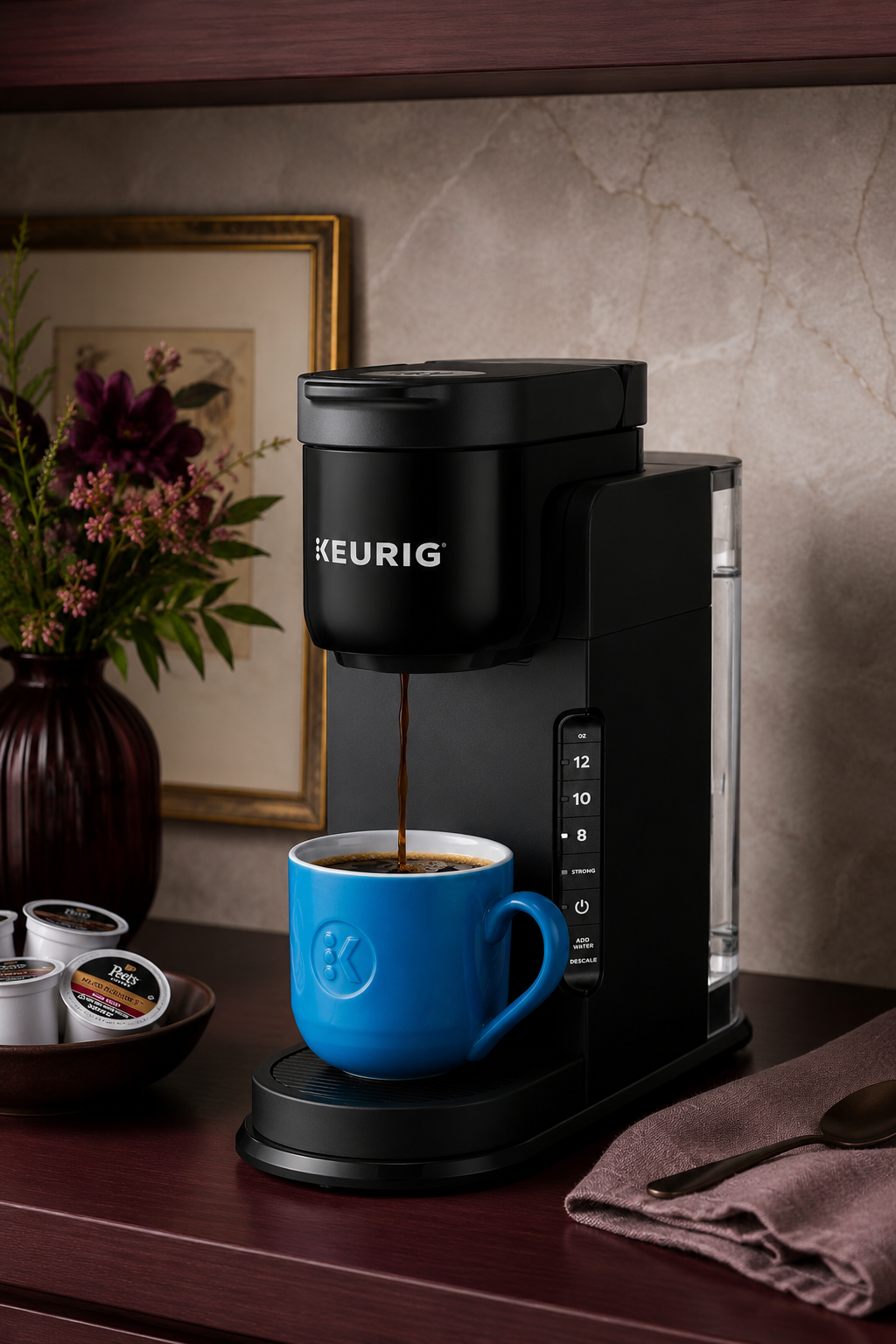 Black Keurig K-Express single serve coffee maker brewing coffee into a blue mug on a kitchen counter.