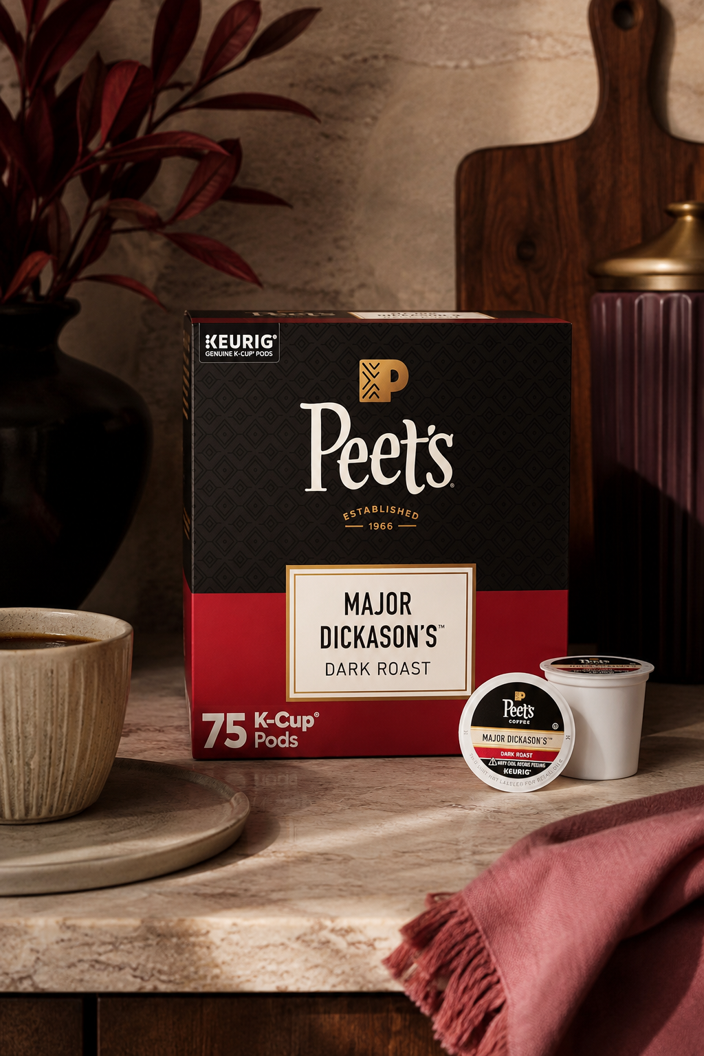 Peet's Major Dickason's Dark Roast K-Cup pods and 75-count box displayed beside a coffee mug on a kitchen counter.